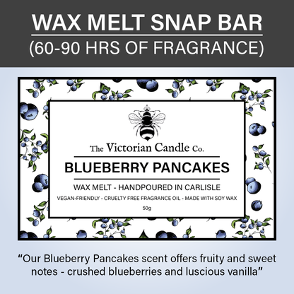 Label for The Victorian Candle Co.'s Blueberry Pancakes Wax Melt Snap Bar, surrounded by blueberries and leaves. The label highlights its delightful scent, emphasizing that it is vegan-friendly and cruelty-free. Made with soy wax in biodegradable packaging, the product provides 60-90 hours of fragrance enjoyment.